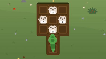 Snake moving onto a T-shaped dirt grid with four number-2 animal tiles in a grassy meadow